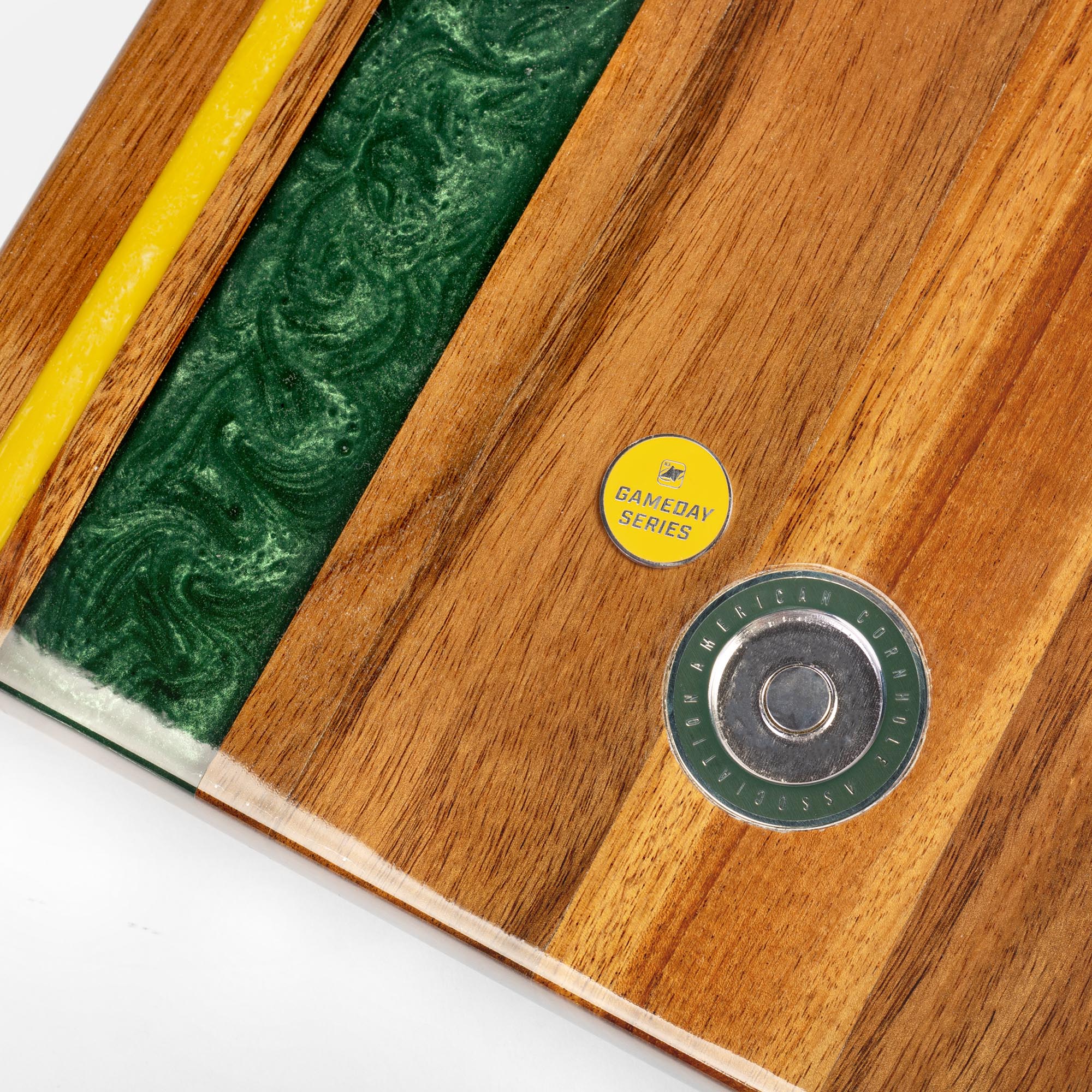 Wooden product with a yellow and green label, and a metallic component on a white background