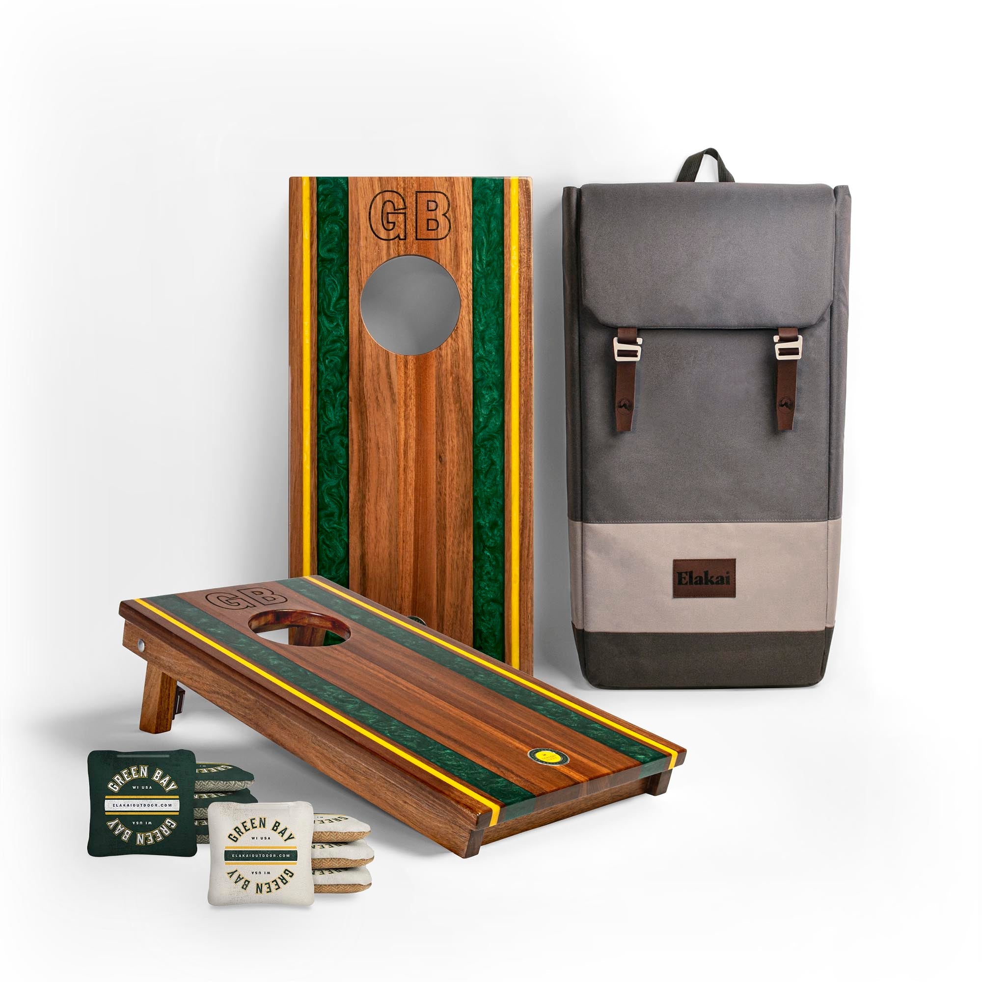 Wooden cornhole boards with green and yellow stripes, a gray backpack, and bags on a white background