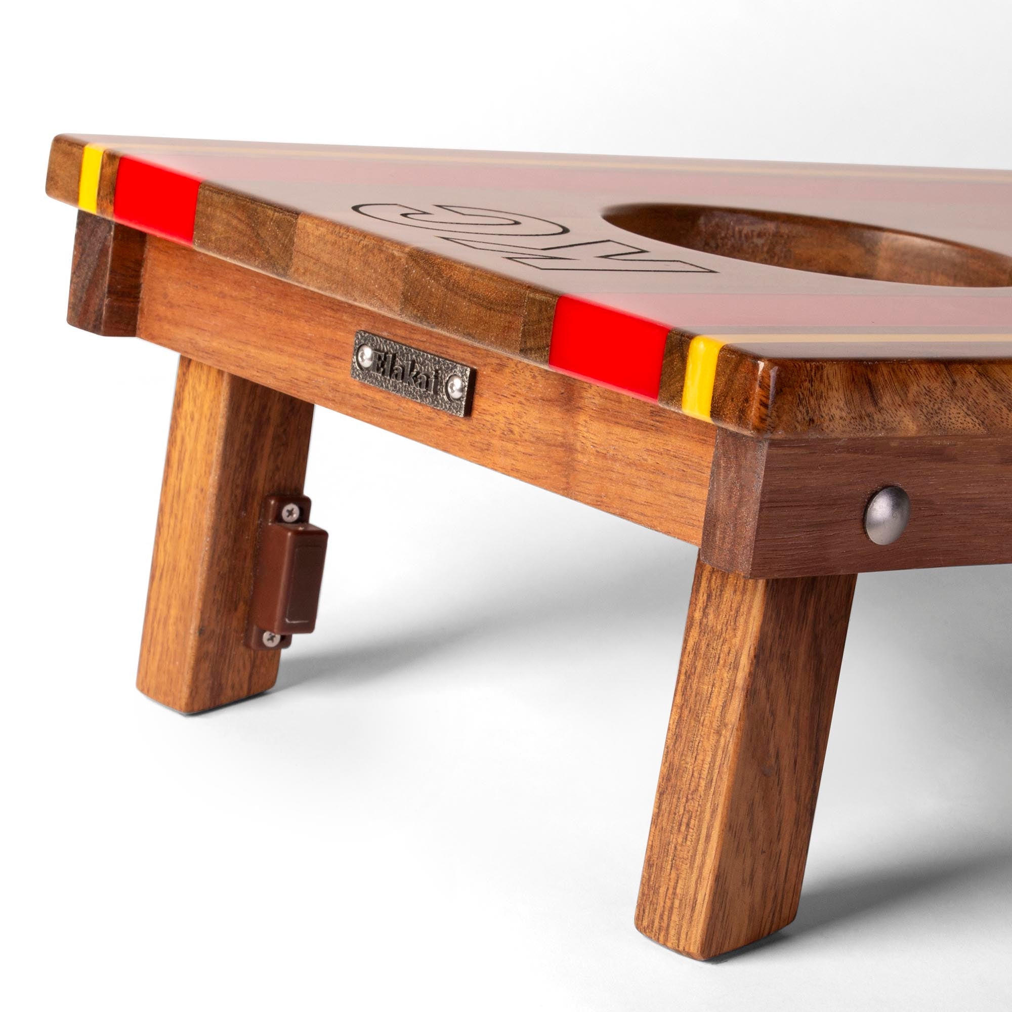 Wooden table with red and yellow accents on a white background