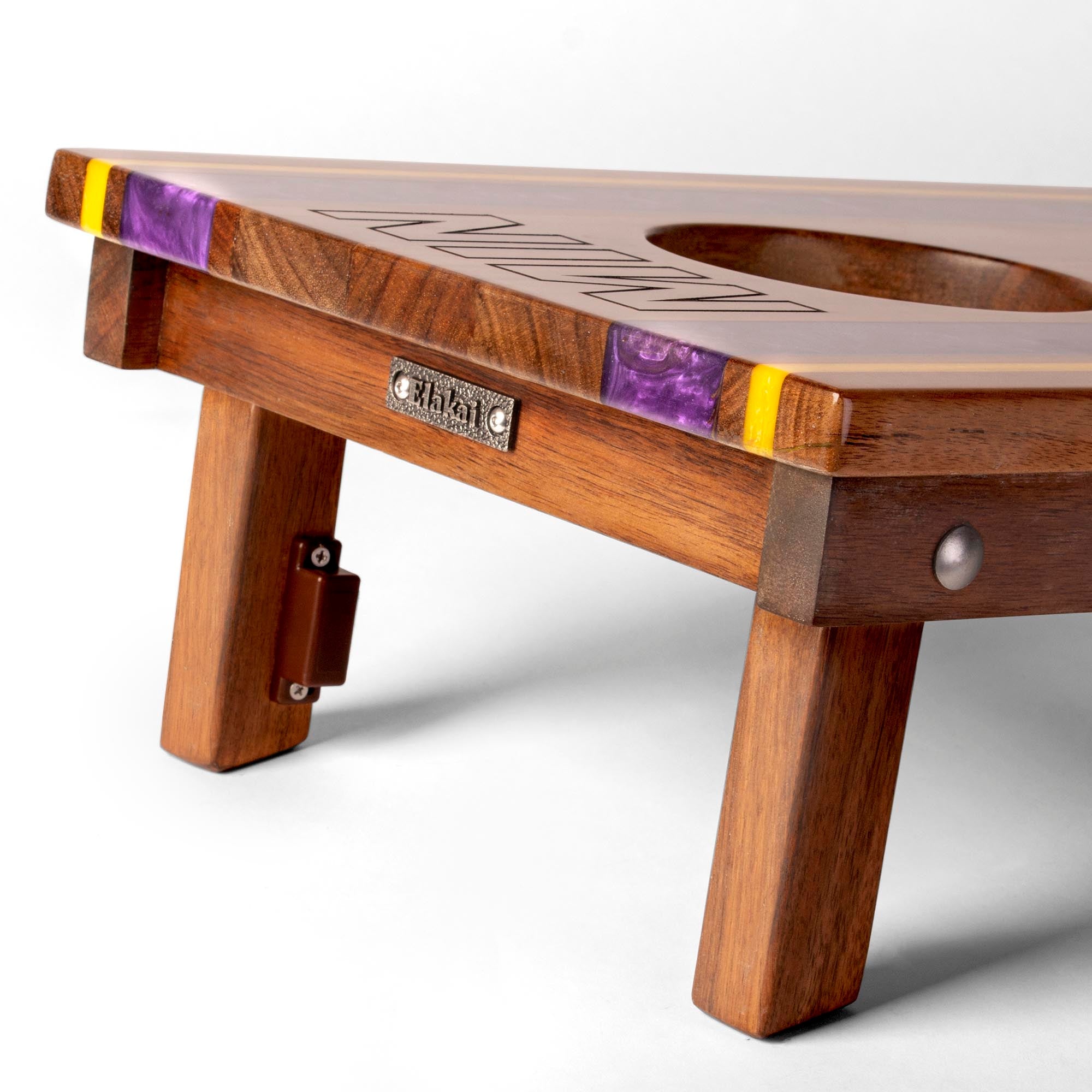 Wooden table with purple and yellow inlays on a white background