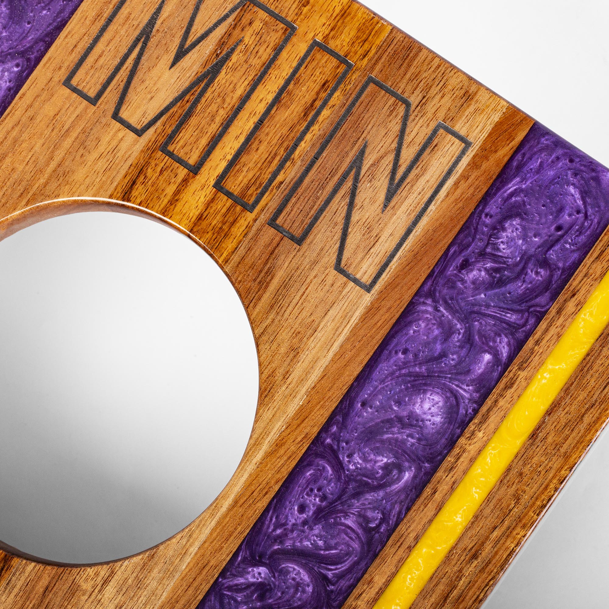 Wooden and purple marbled coaster with 'MIN' engraving