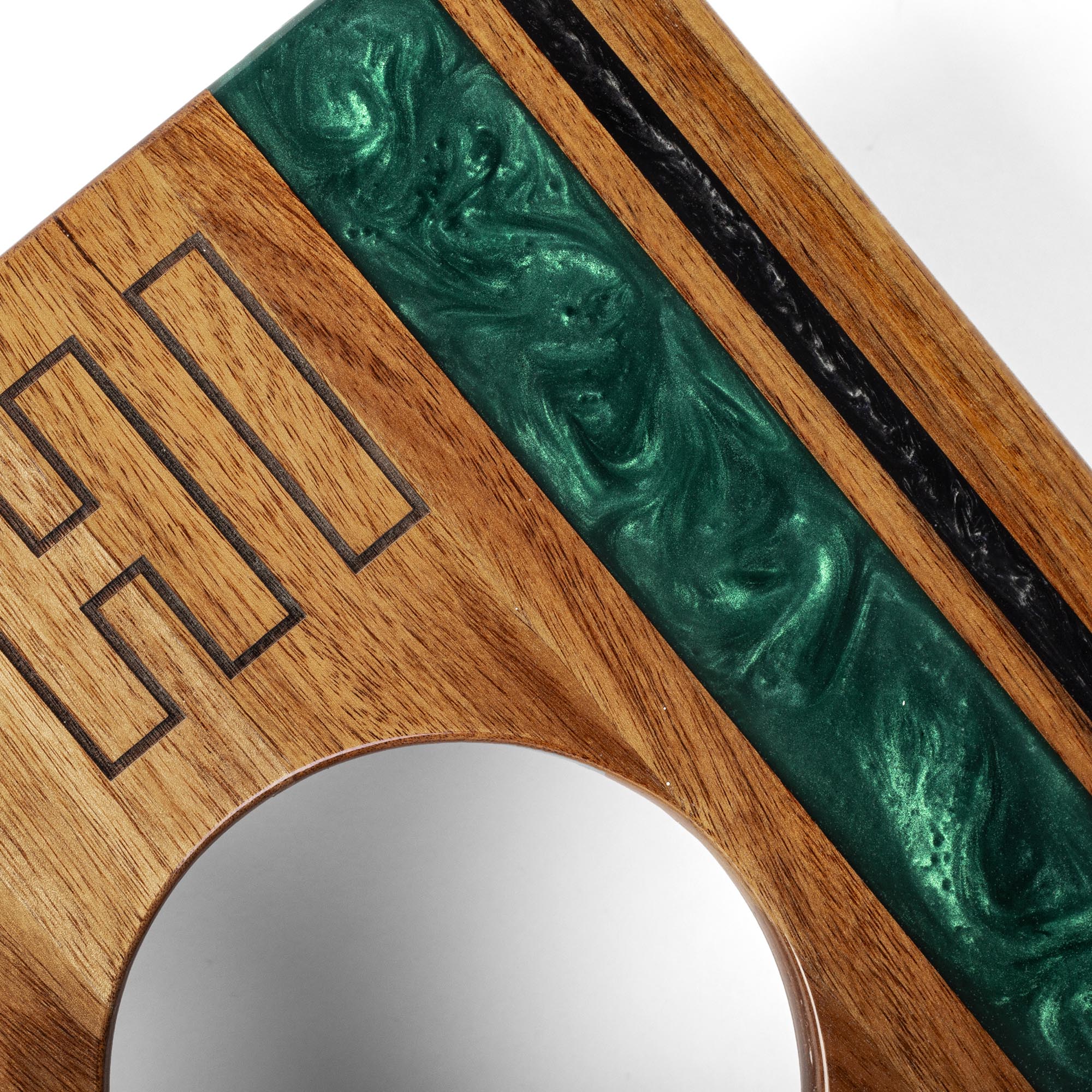 Wooden and green decorative item with a circular mirror