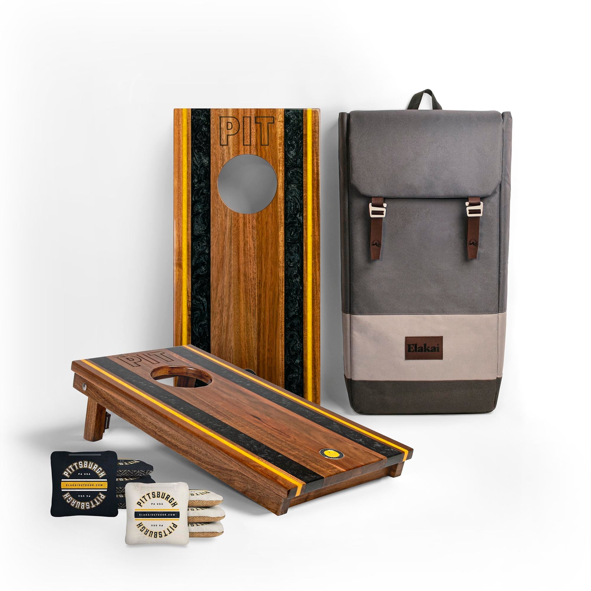 Cornhole boards with bags and a backpack on a white background