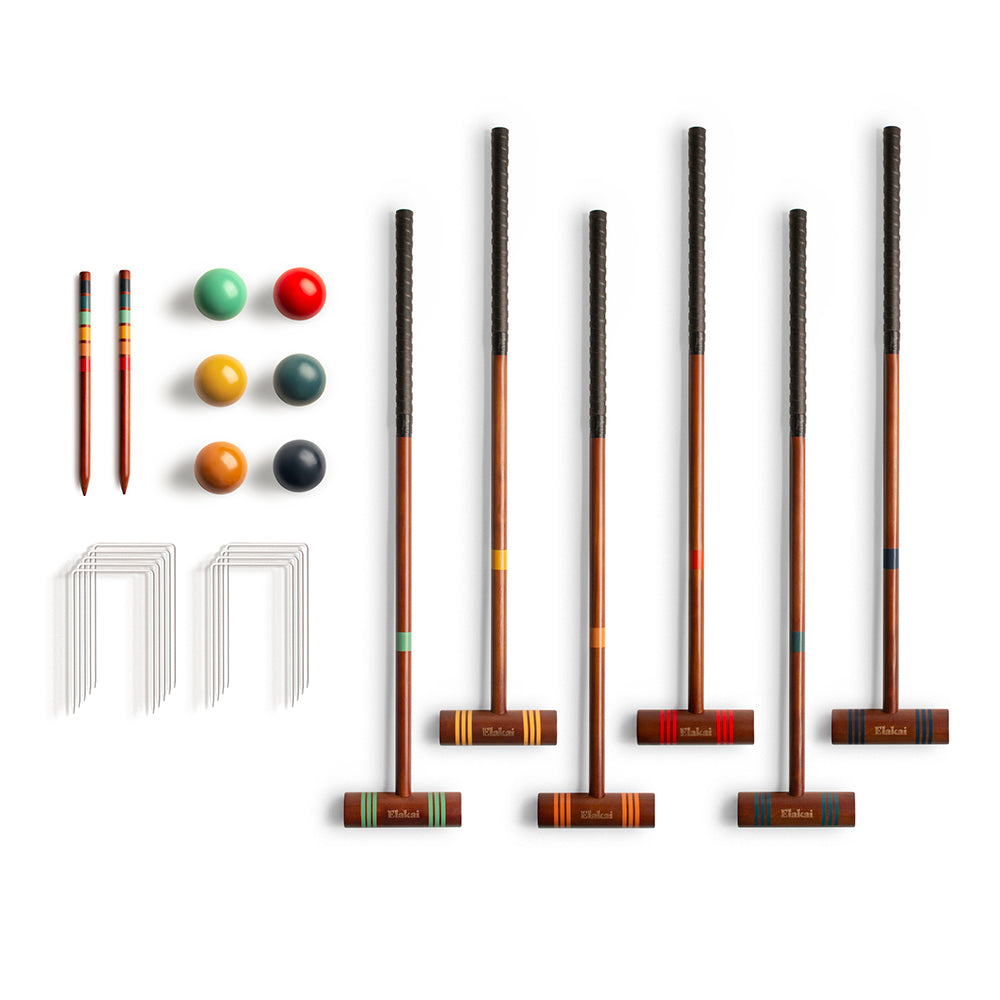 Set of croquet mallets and balls on a white background