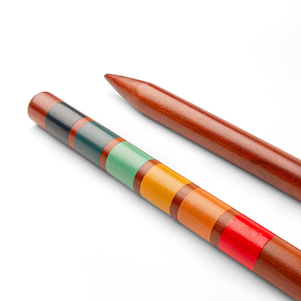 Colorful striped pen and a plain brown pen on a white background