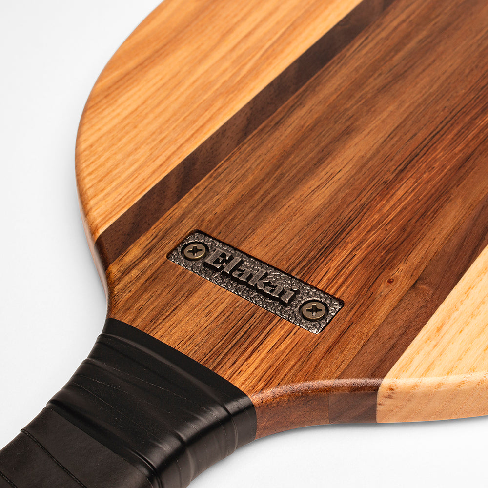 Wooden paddle with a brand logo on a white background