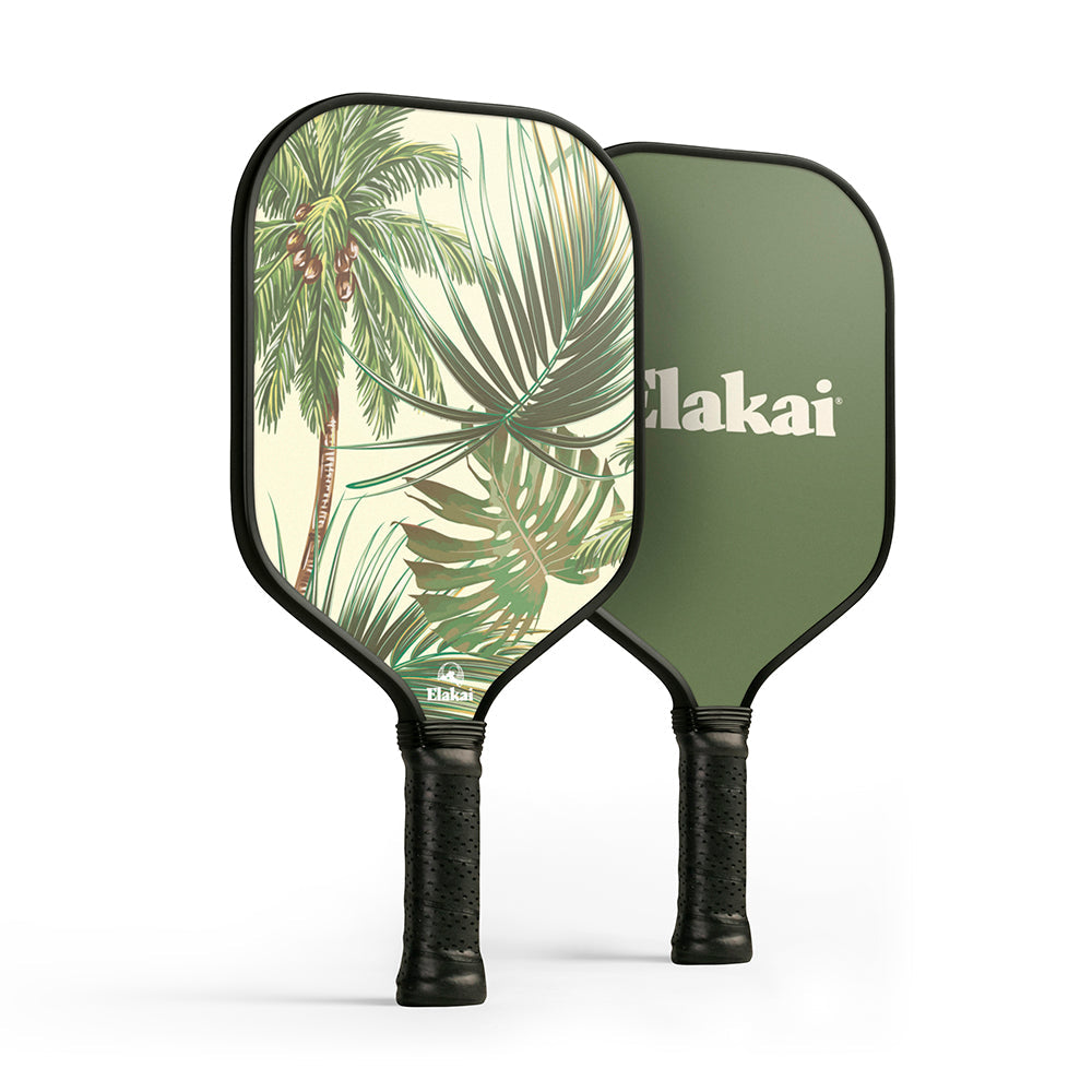 Two pickleball paddles with one featuring a palm tree design and the other green with 'Elakai' branding.