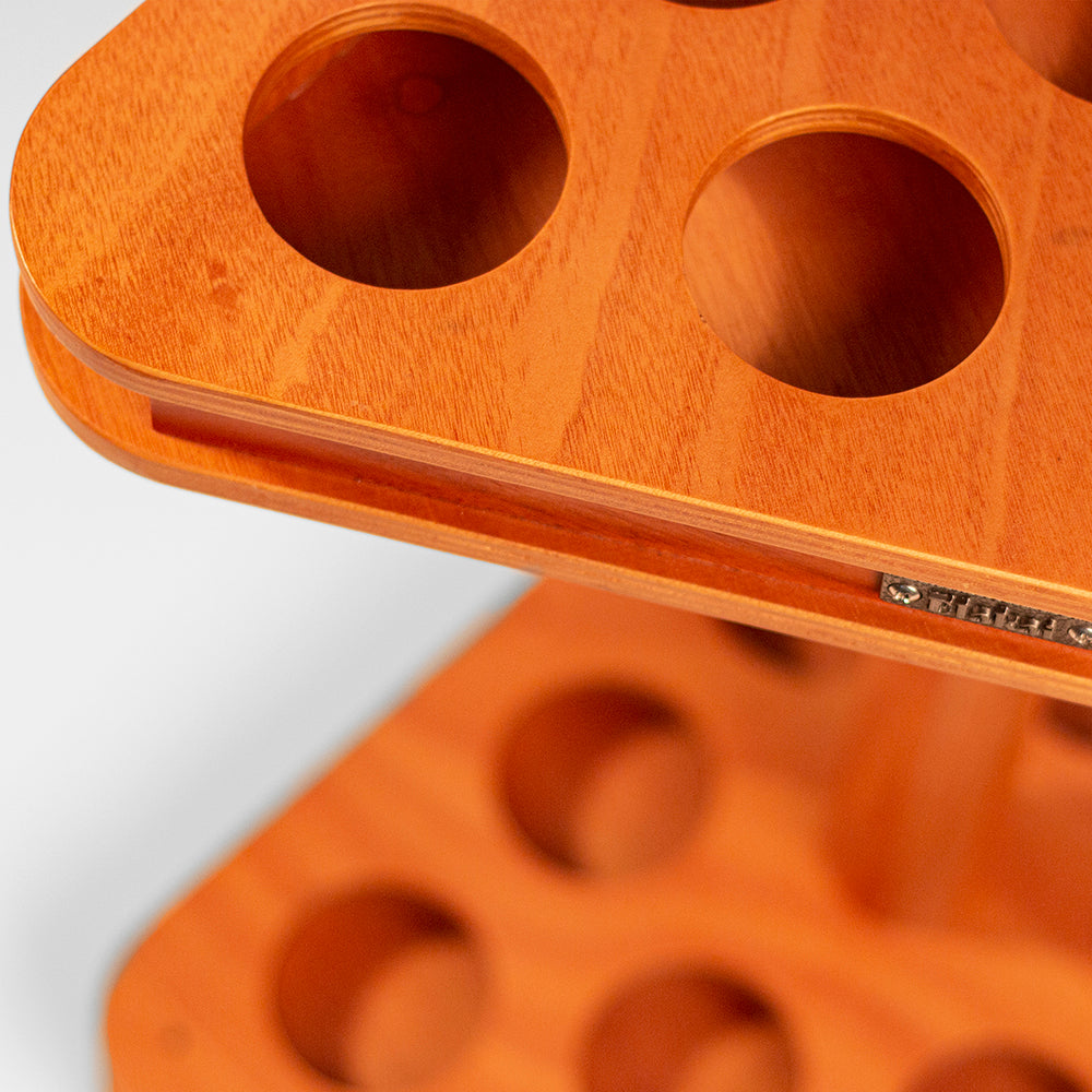 Close-up of an orange plastic mold with multiple circular cavities on a white background.