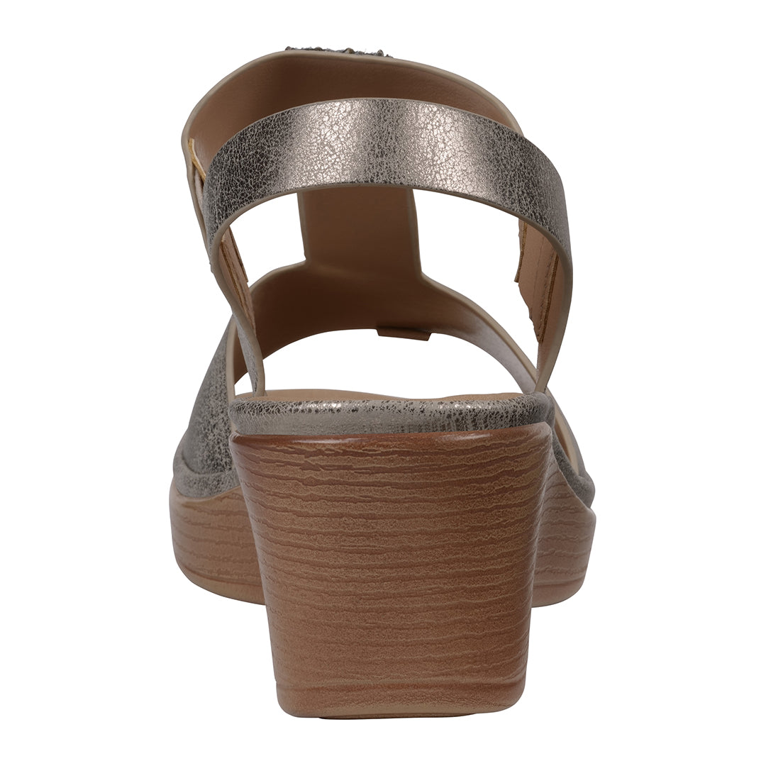 Brown sandal with metallic strap on a white background