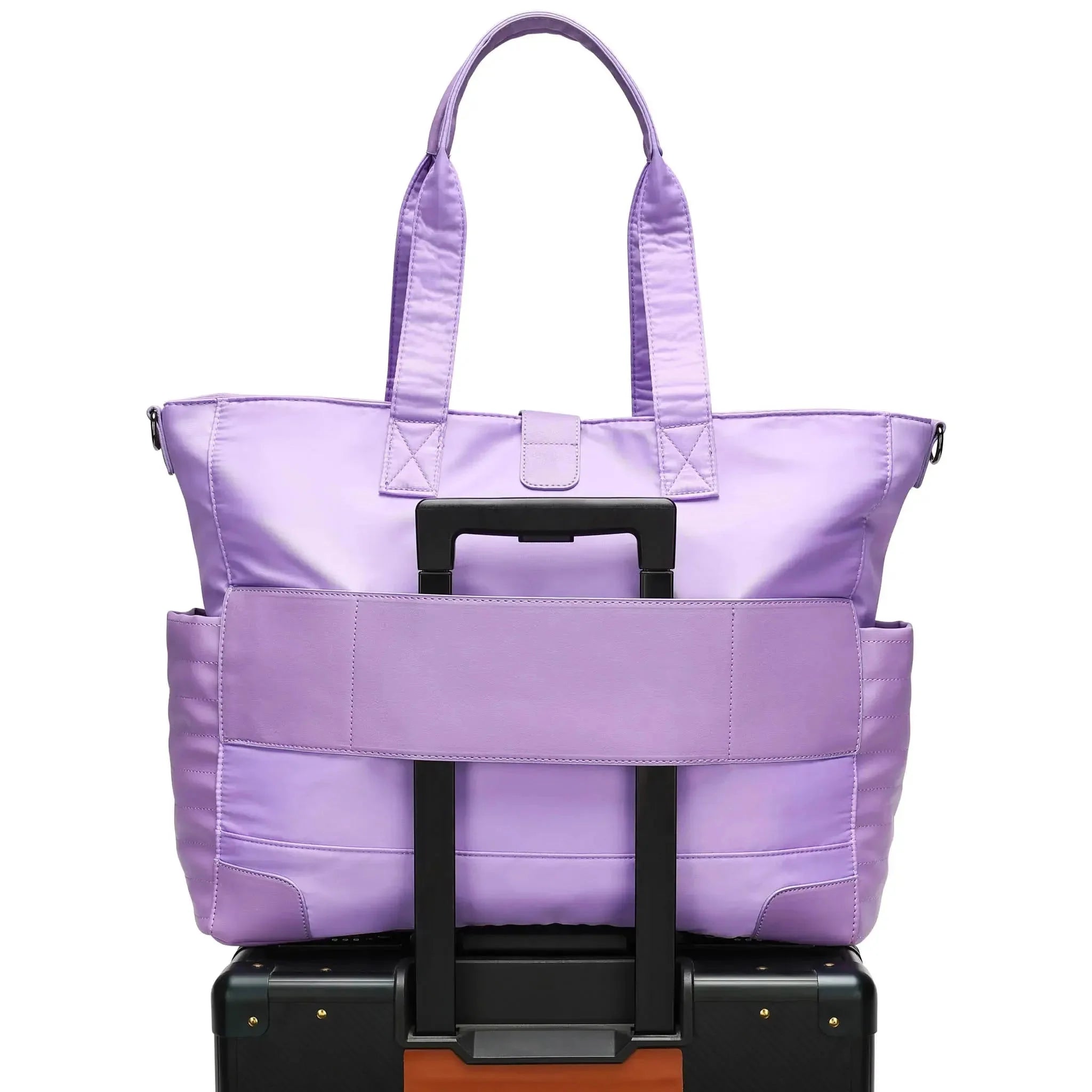 Purple tote bag with a handle on top of a black suitcase