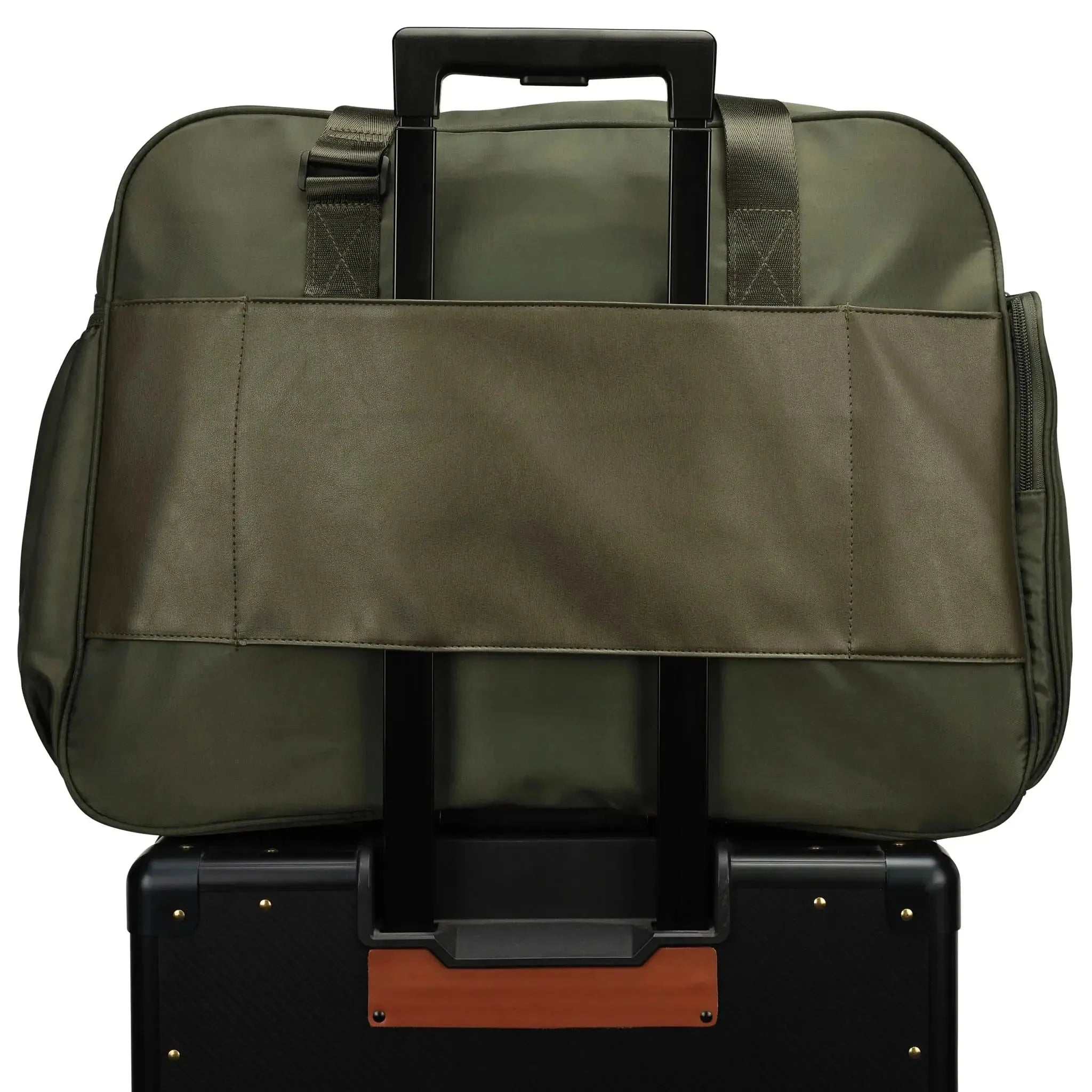 Green duffel bag on top of a black suitcase with brown accents