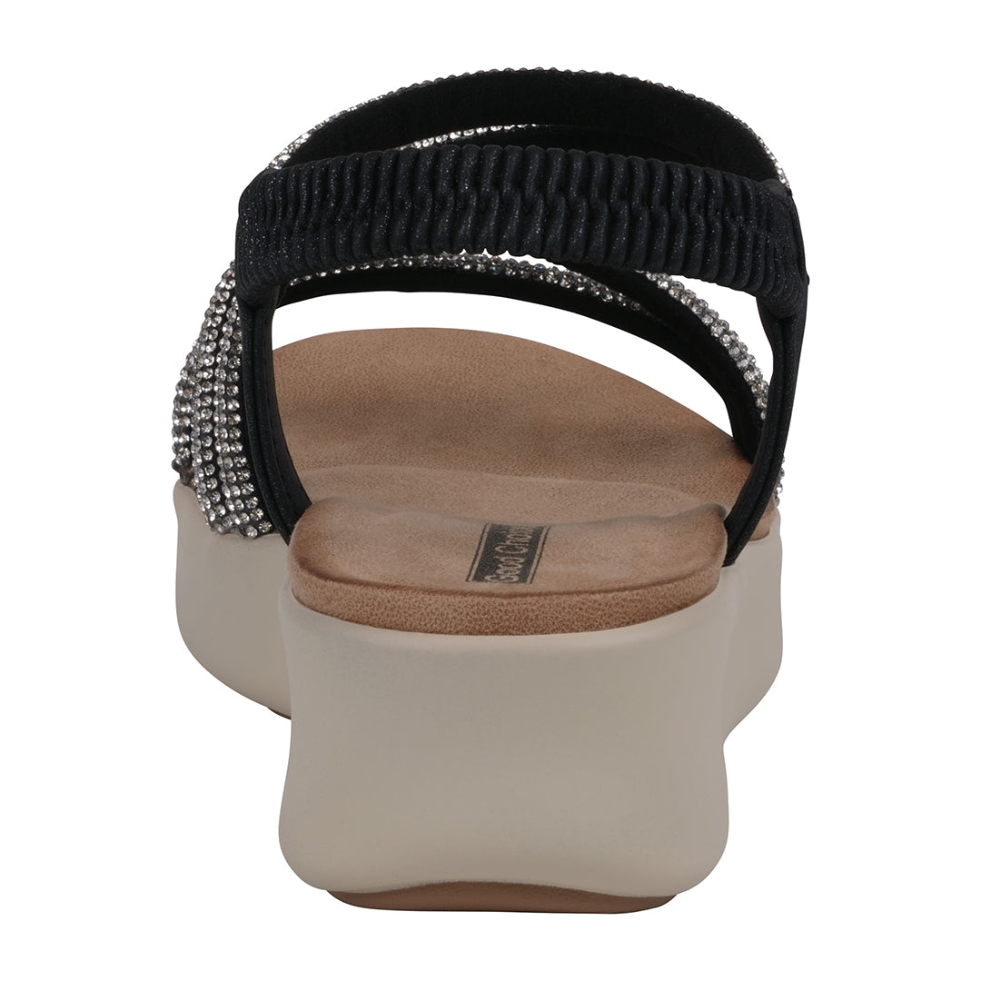 Black sandal with rhinestone embellishments on a white background