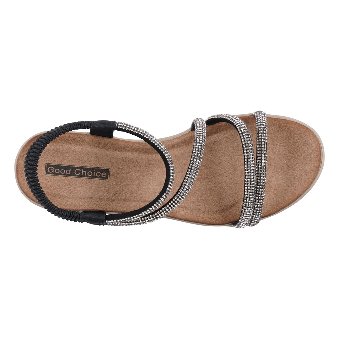 Brown sandal with decorative straps on a white background