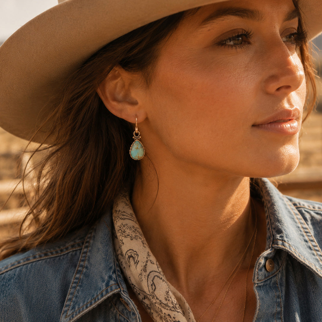 Woman wearing a cowboy hat and denim jacket with a blurred background