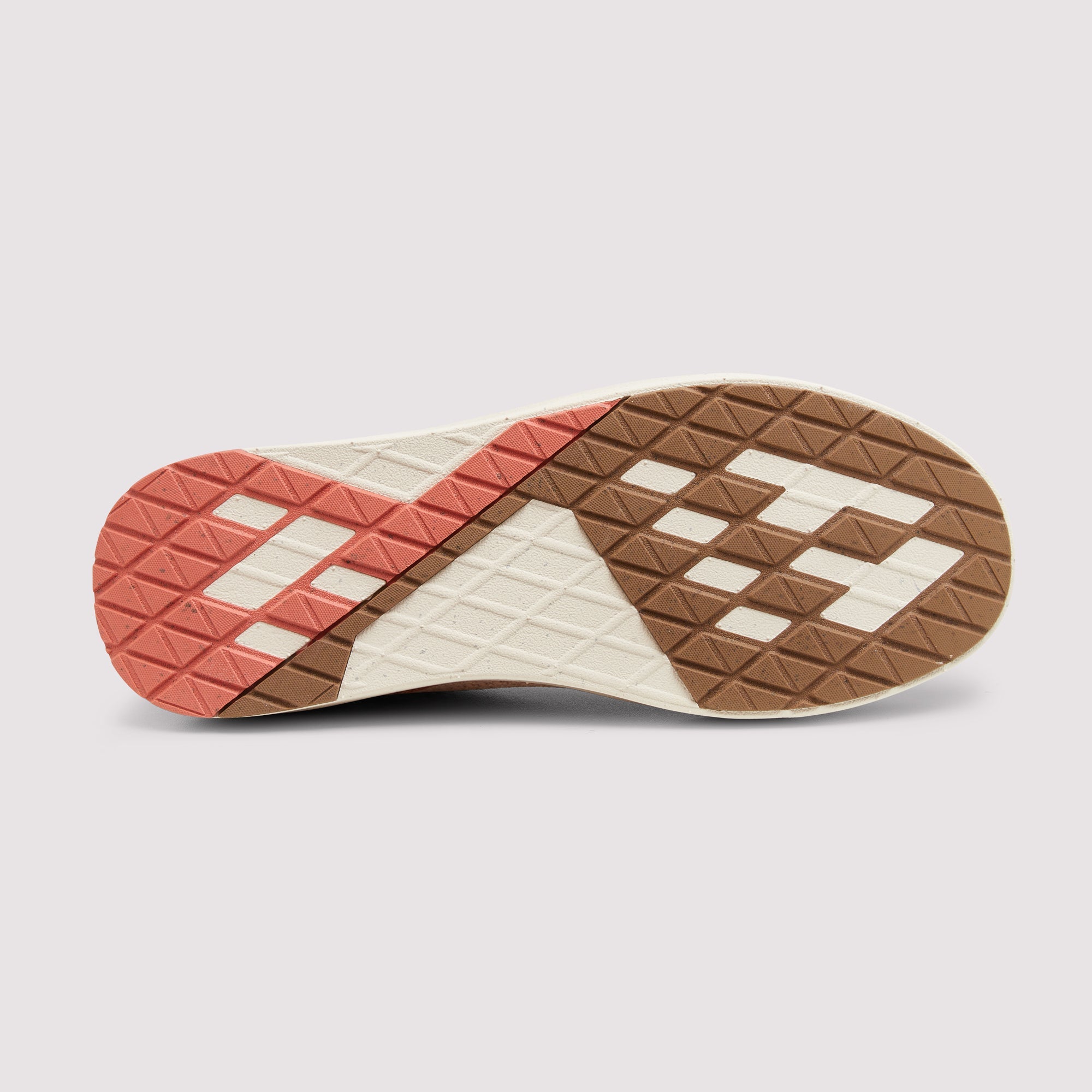 The outsole of a sneaker shown from a top-down view, featuring a geometric pattern in brown, off-white, and coral pink on a light gray background.