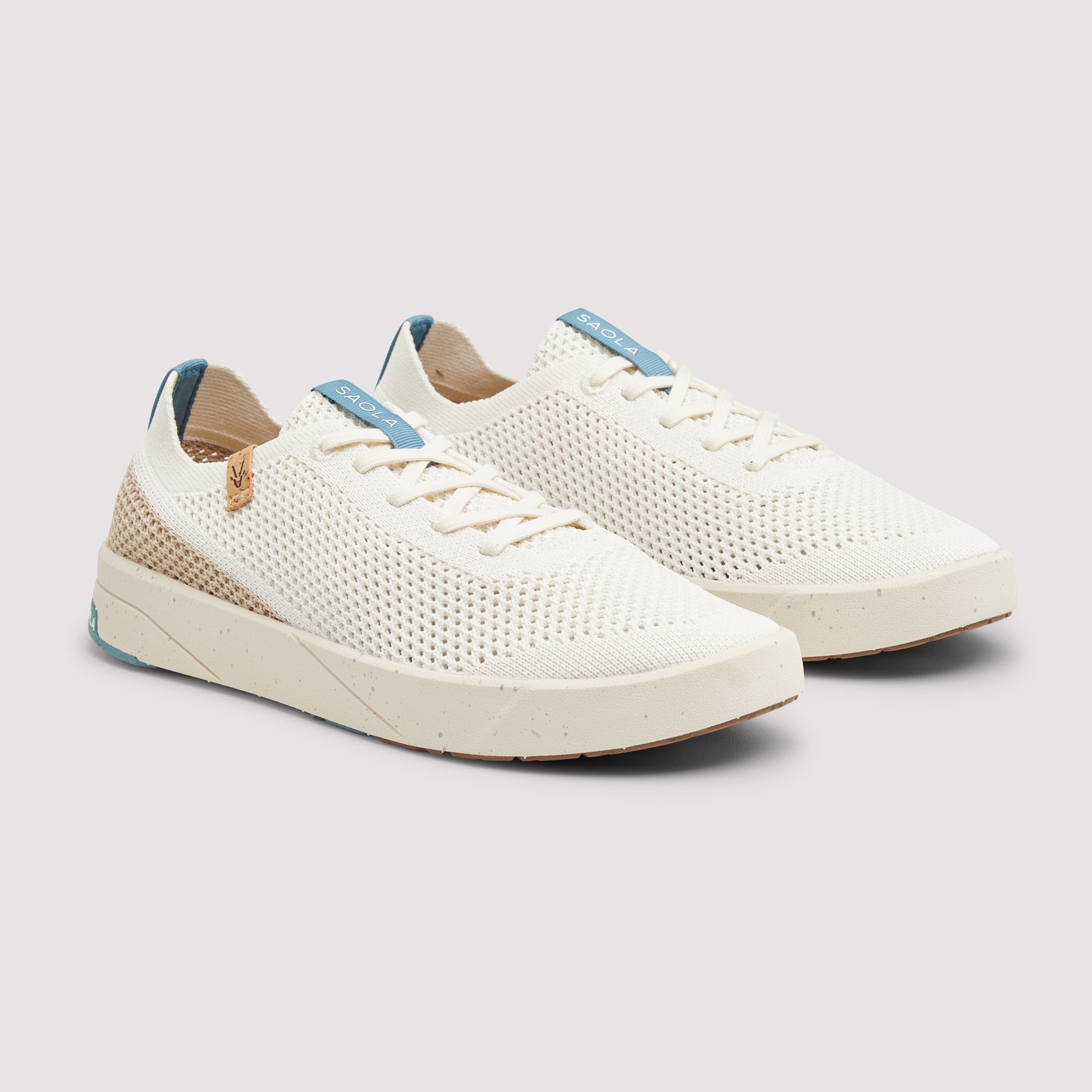 A pair of low-top mesh sneakers in off-white with light blue accents on the tongue labels and heel, beige woven side panels, and cream-colored soles, shown on a light gray background.
