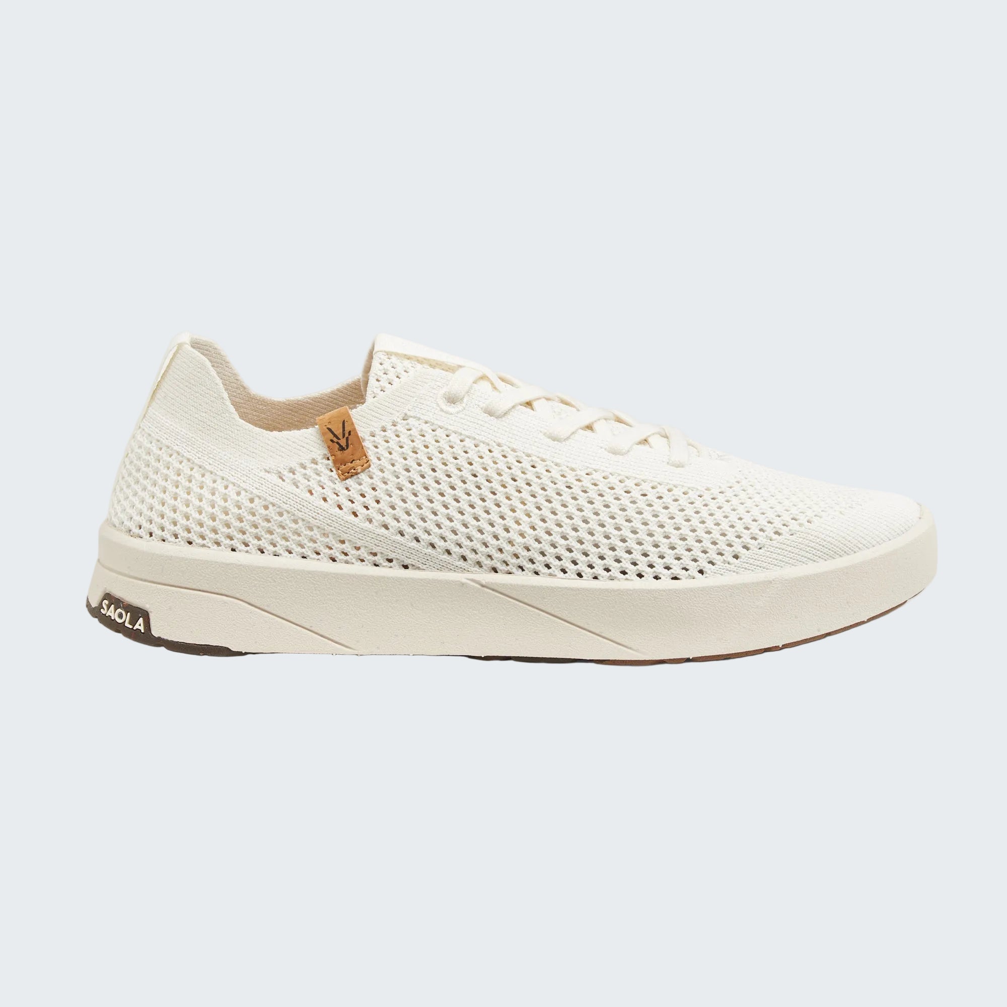 A single white mesh sneaker shown in a side profile on a light gray background. The shoe features a white knit upper, white laces, a thick white sole, and a small brown leather accent on the side with a logo, and a small brown heel tab with the brand name 'FACLORA' visible.