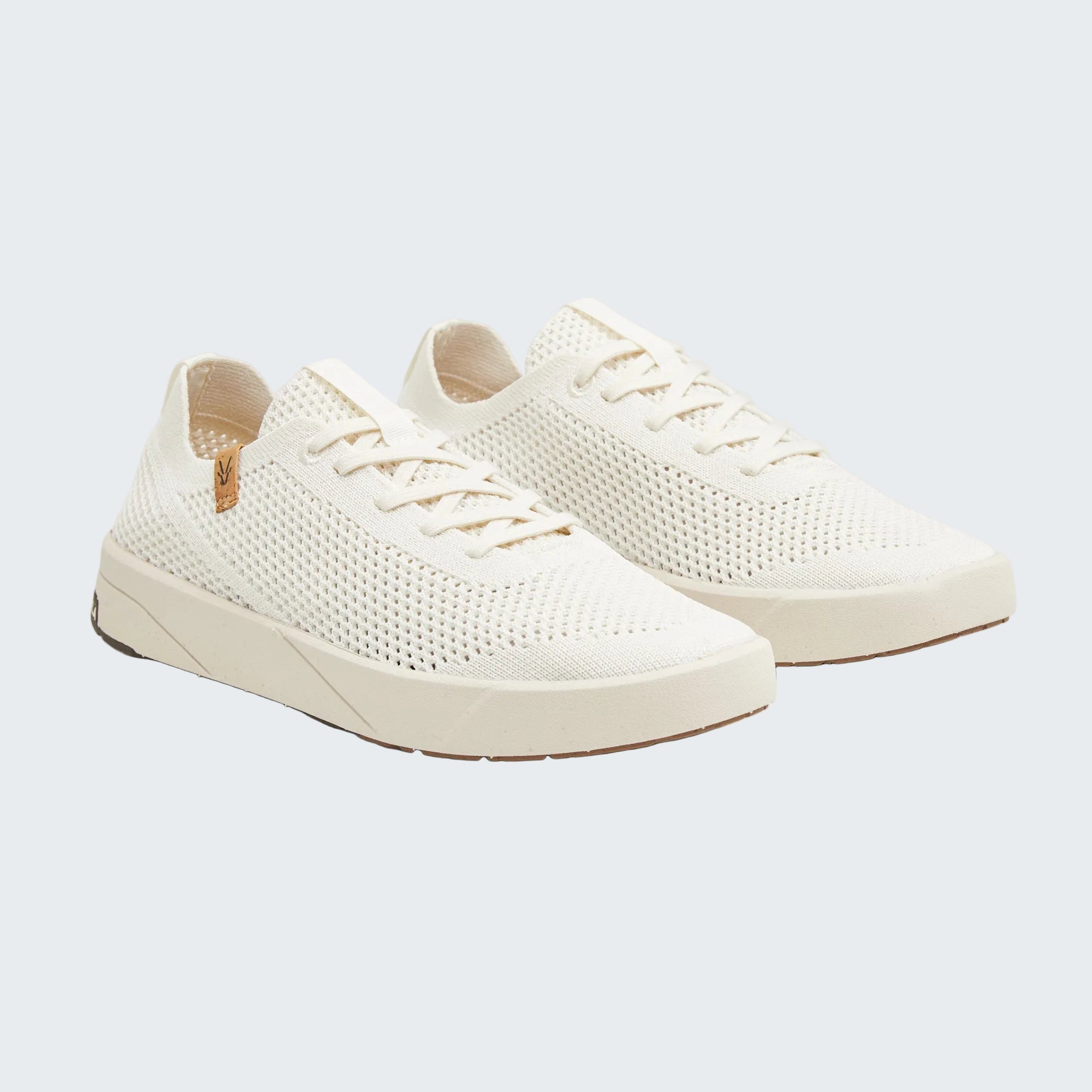 A pair of low-top knit sneakers in off-white with matching laces and thick platform soles, shown on a light gray background.