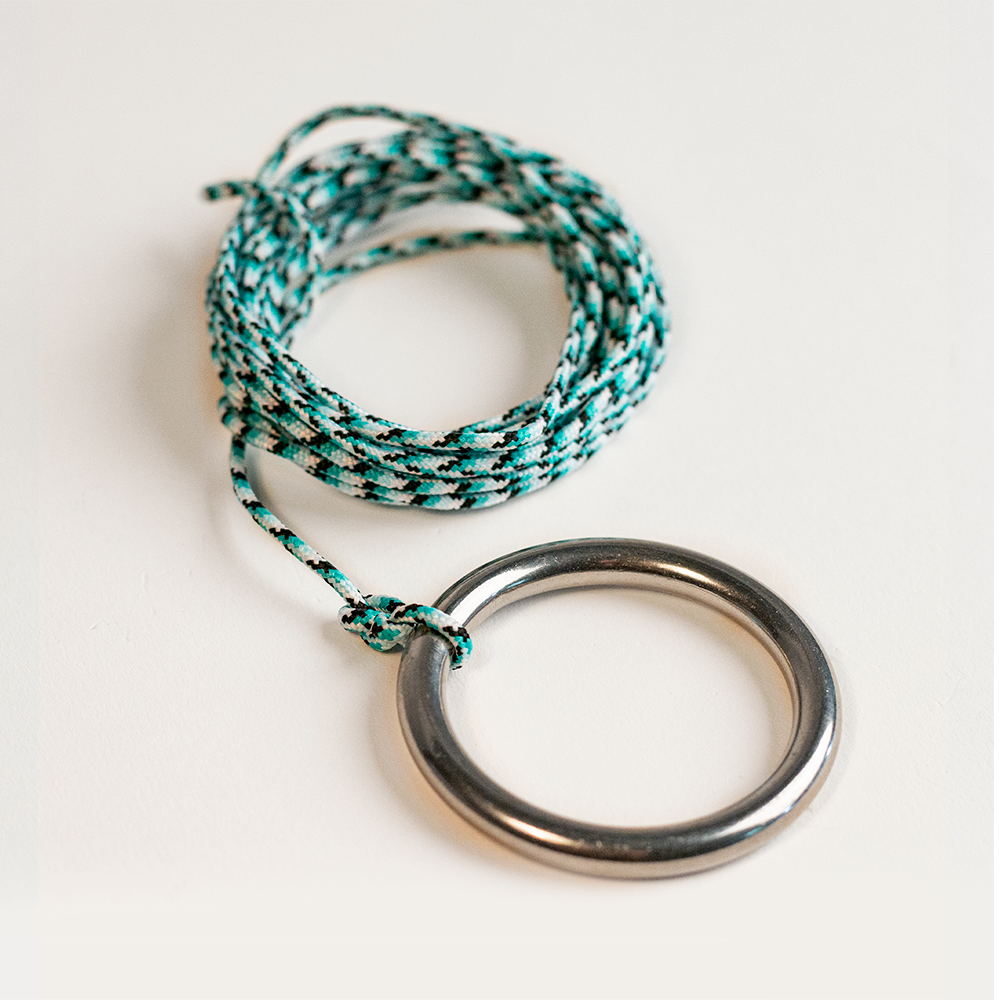 Bracelet with braided design and metal ring on a white background