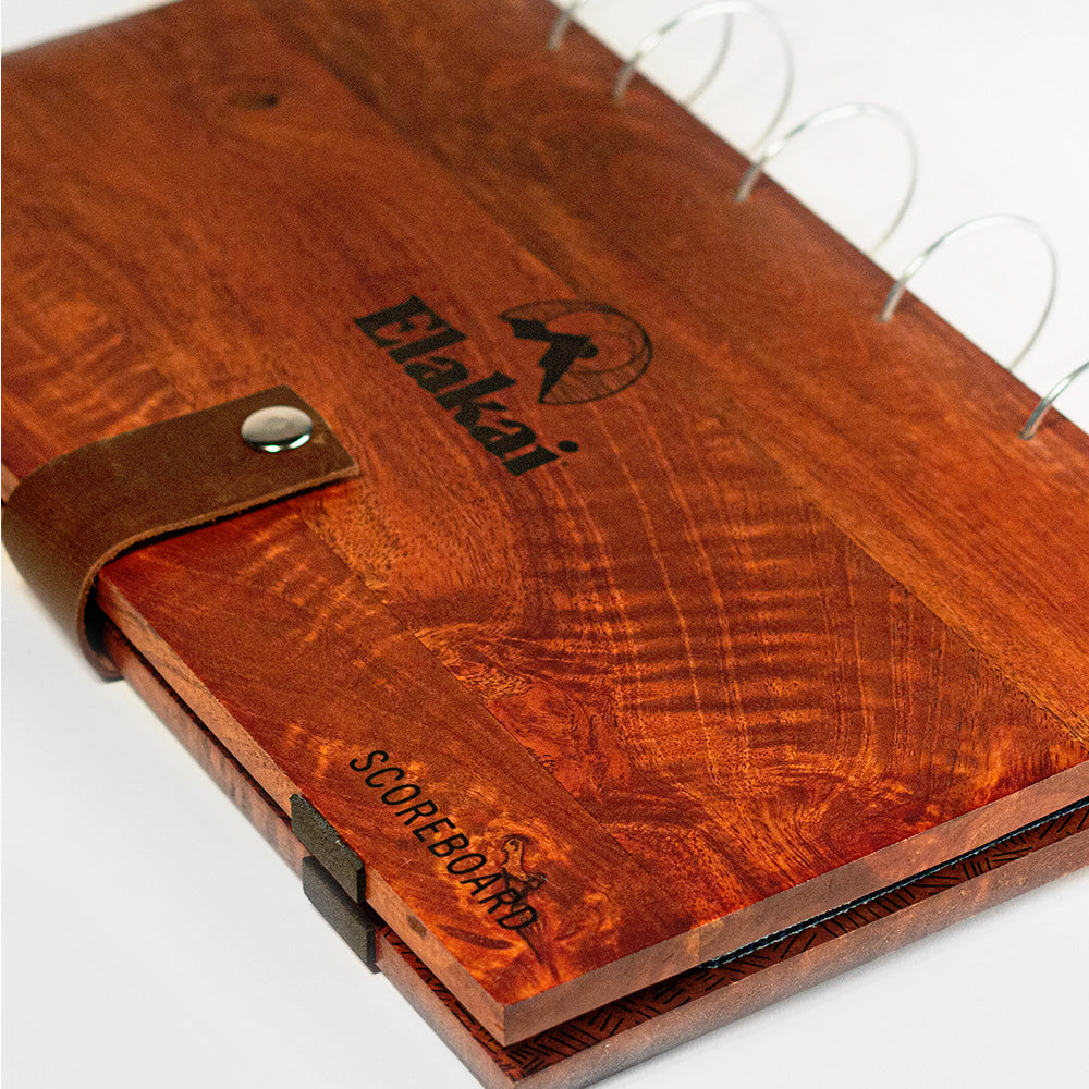 Wooden scorecard holder with leather strap and 'Elakait' branding on a white background