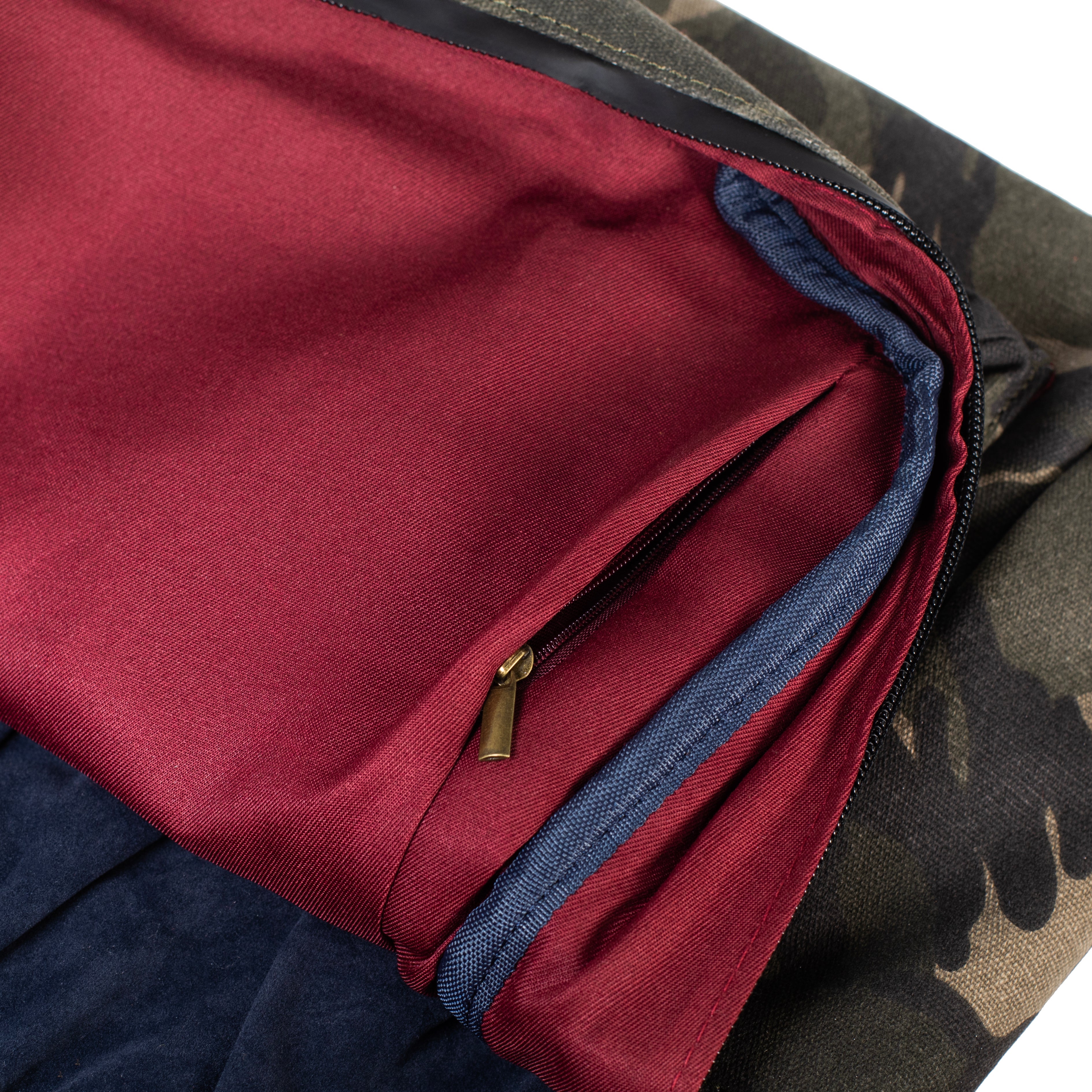 Close-up of a multicolored fabric with red, blue, and camouflage patterns.