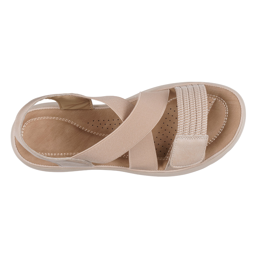 Beige sandal with criss-cross straps on a white background