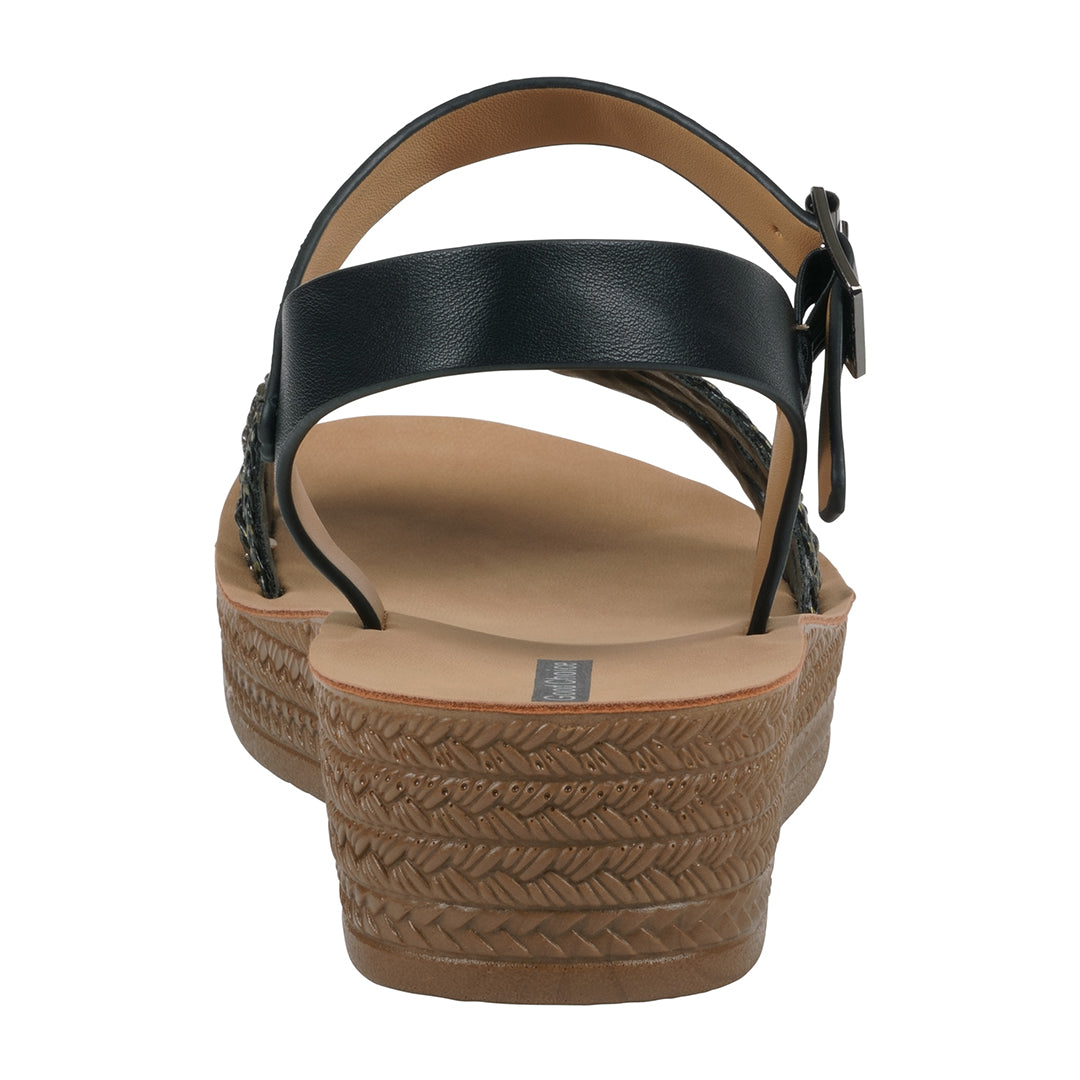 Black sandal with a tan wedge sole on a white background