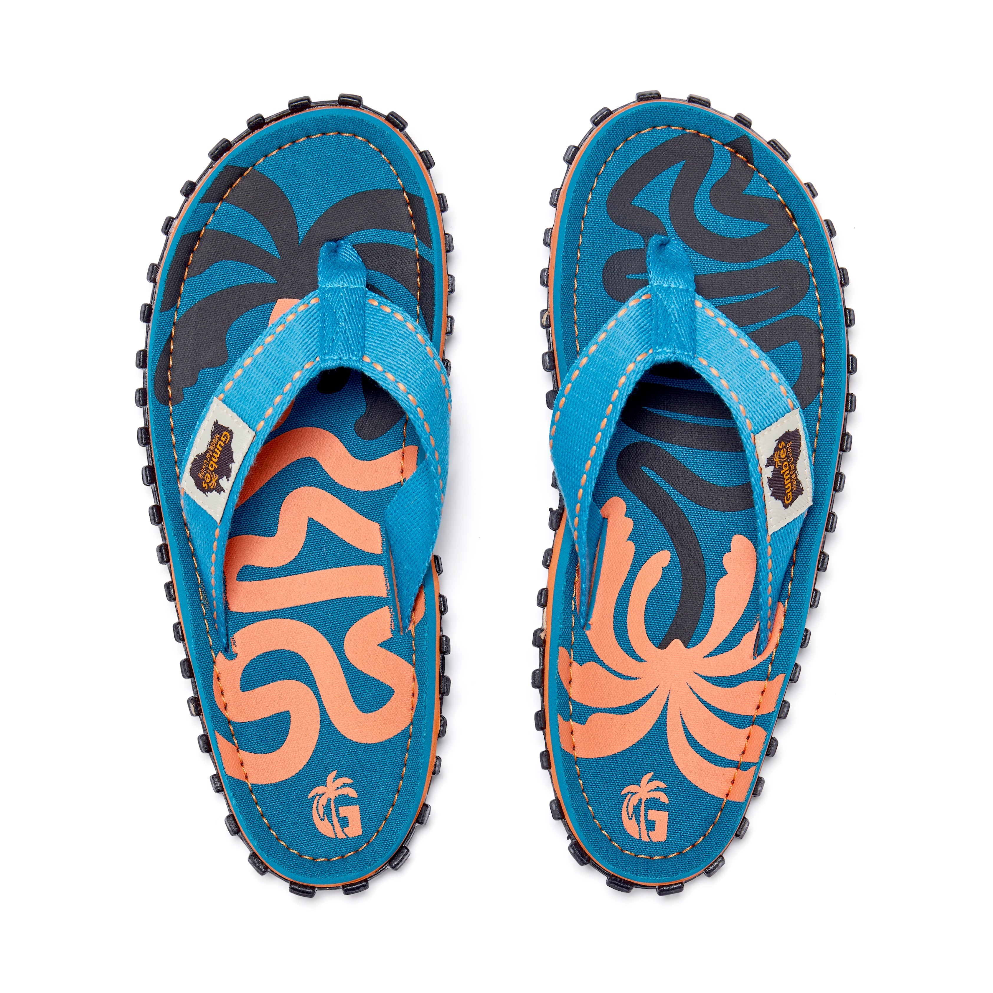 Pair of blue flip-flops with orange and black designs on a white background