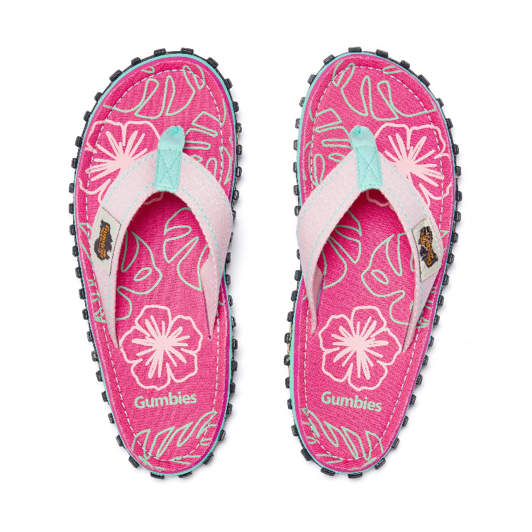 Pink flip-flops with floral design and 'Gumbies' branding on a white background
