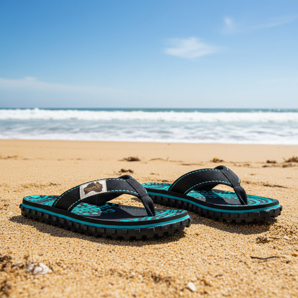 Pair of black and teal sandals with a brand logo on a white background