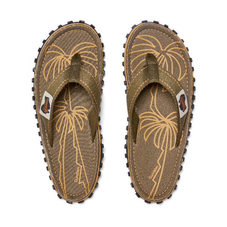 Pair of brown flip-flops with palm tree design on a white background