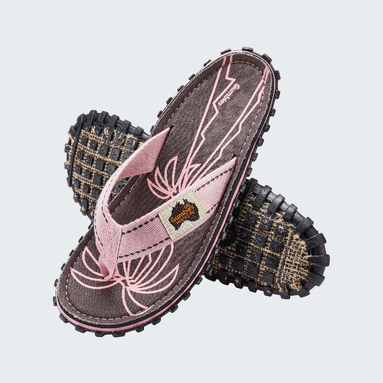 Pair of children's sandals with pink floral design on a white background