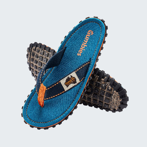 Blue flip-flops with orange accents and 'Bumbies' branding on a white background