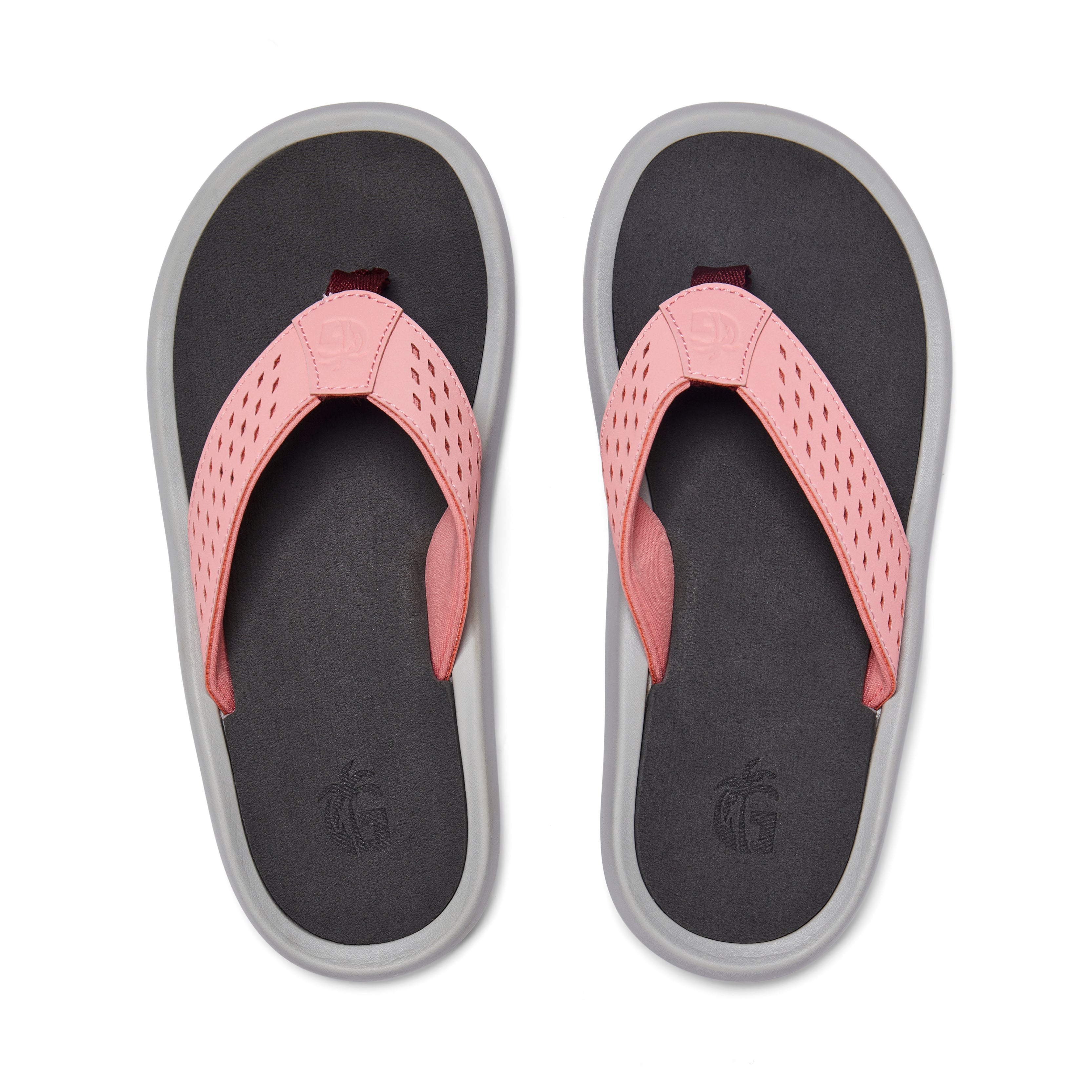 Pair of flip-flops with pink straps and black soles on a white background