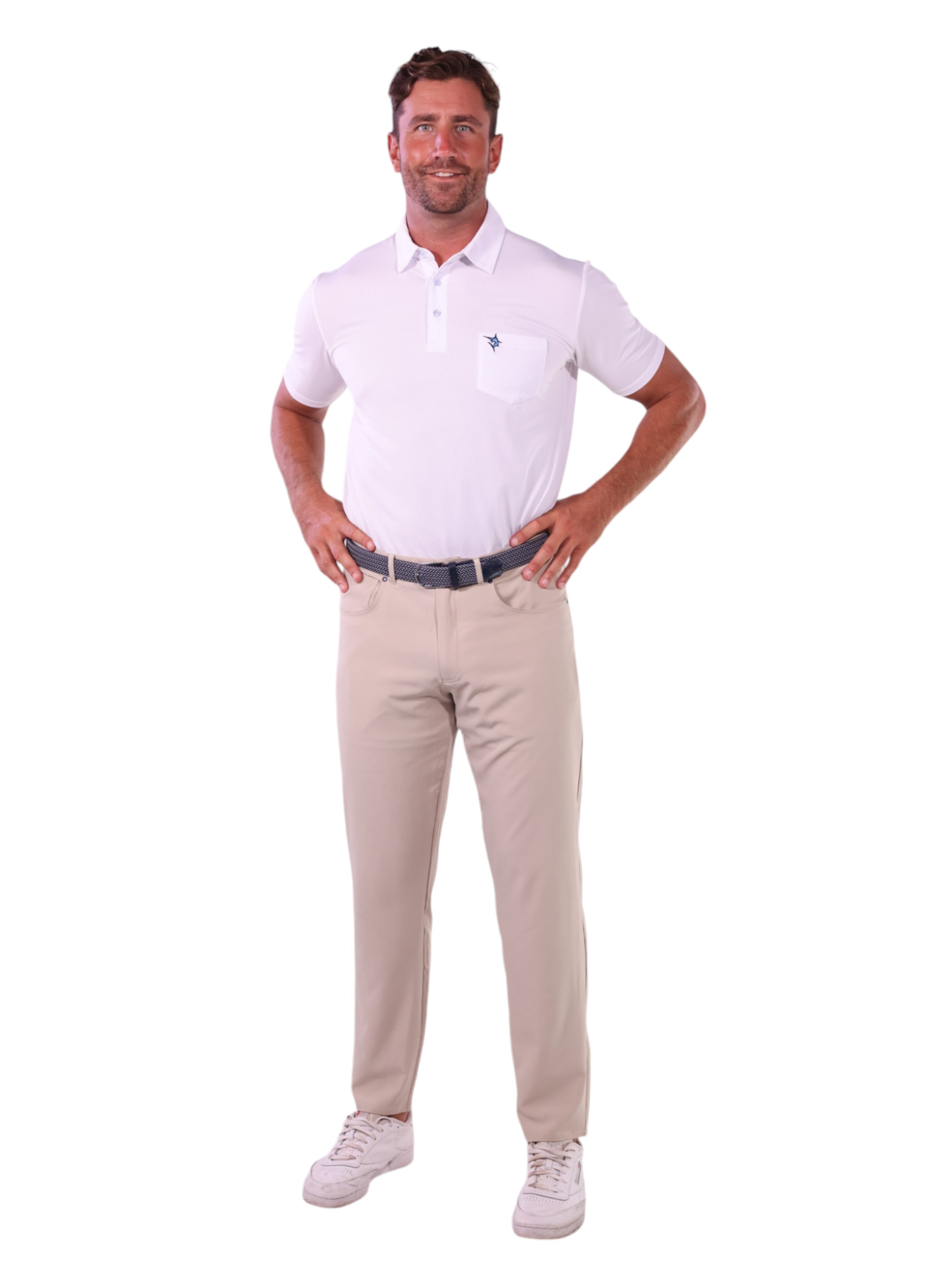 Man wearing a white polo shirt and beige pants on a white background