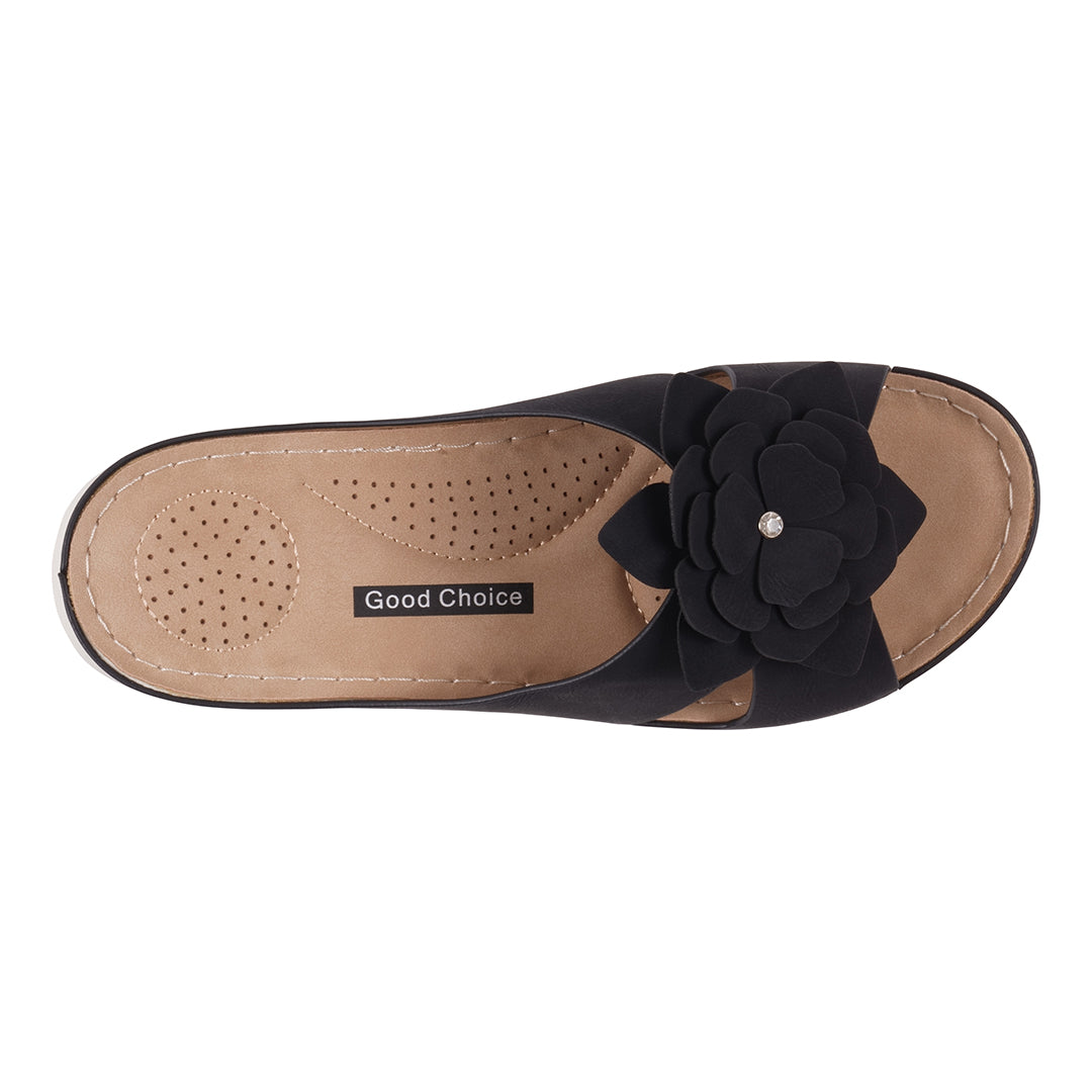 Black sandal with a flower detail on a white background