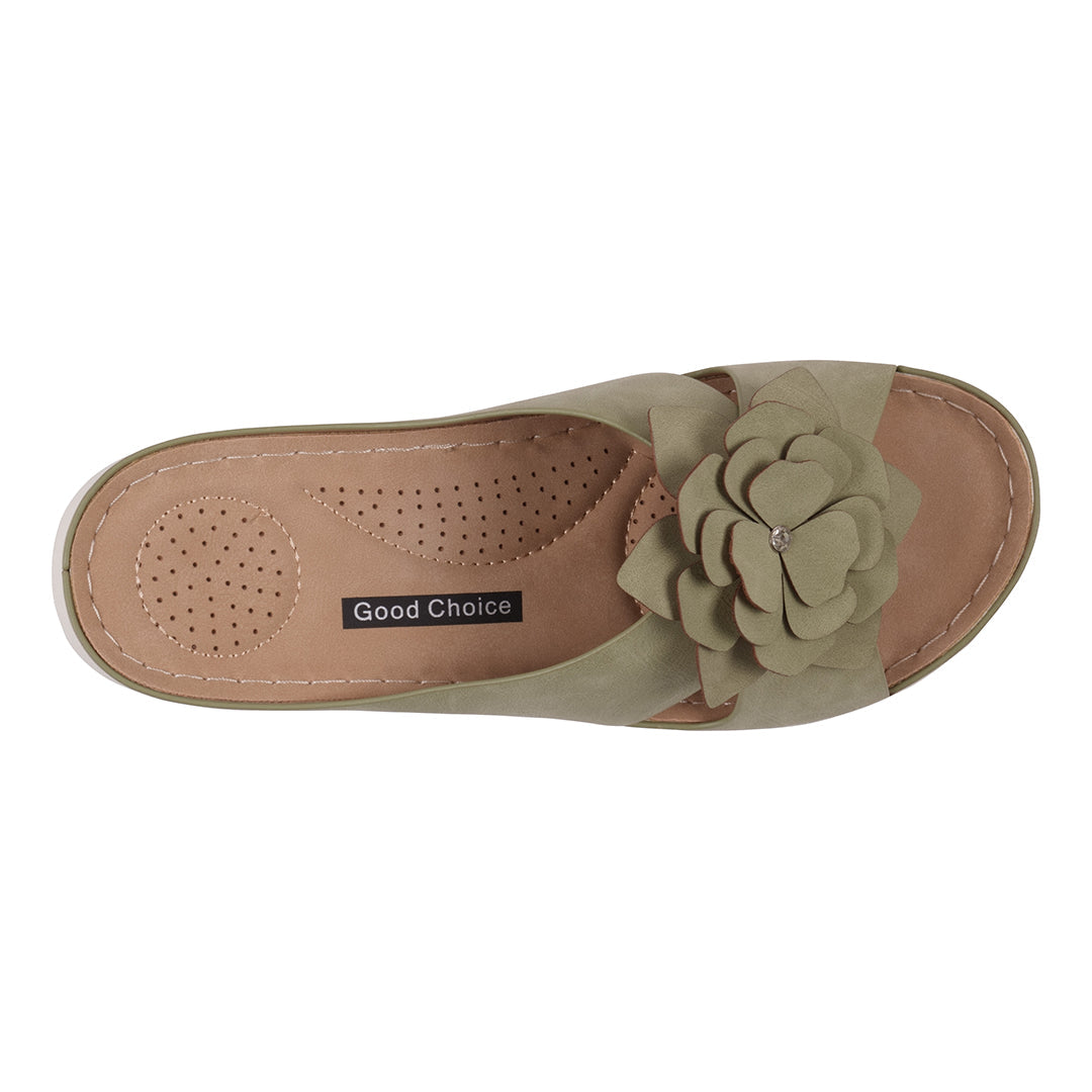 Green sandal with a flower detail on a white background