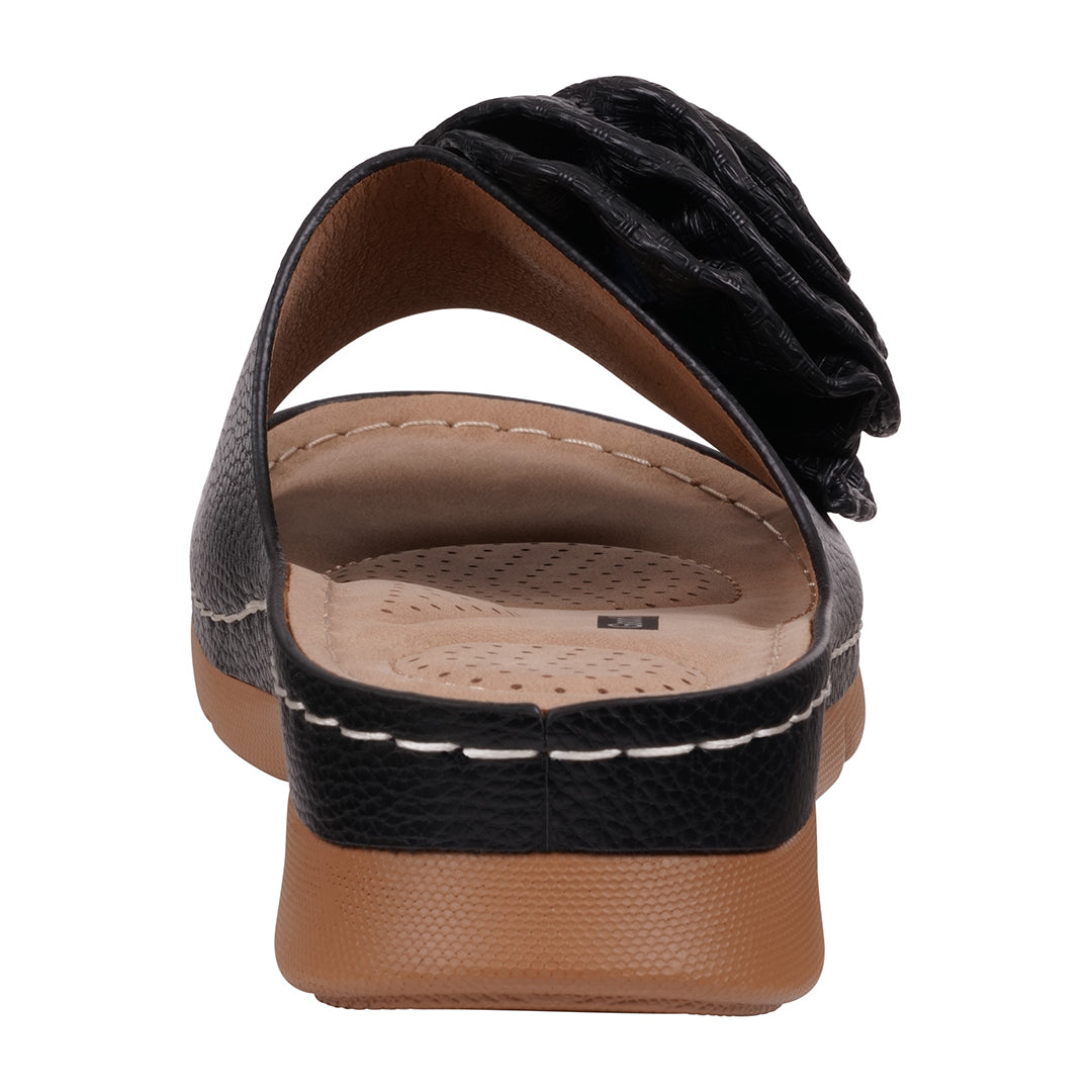 Black sandal with a flower detail on a white background