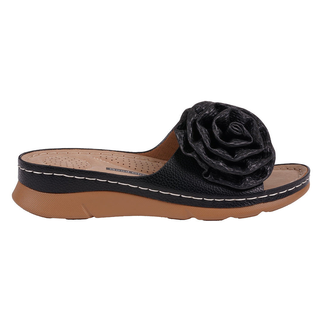Black sandal with a flower detail on a white background