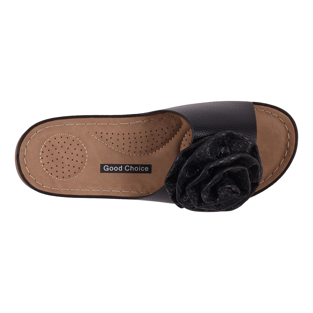 Sandal with black flower detail on a white background