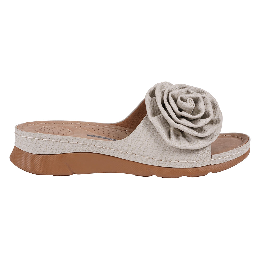Beige sandal with a flower detail on a white background