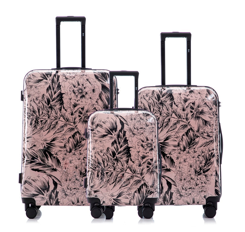 Set of three floral-patterned suitcases on a white background