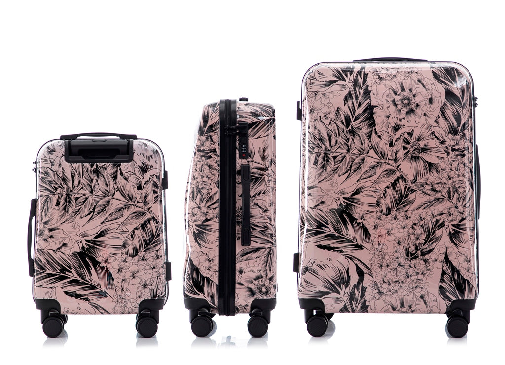 Set of three floral-patterned suitcases on a white background