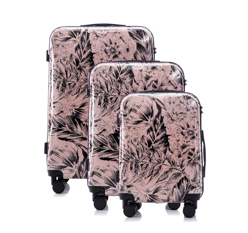 Set of three floral-patterned suitcases on a white background