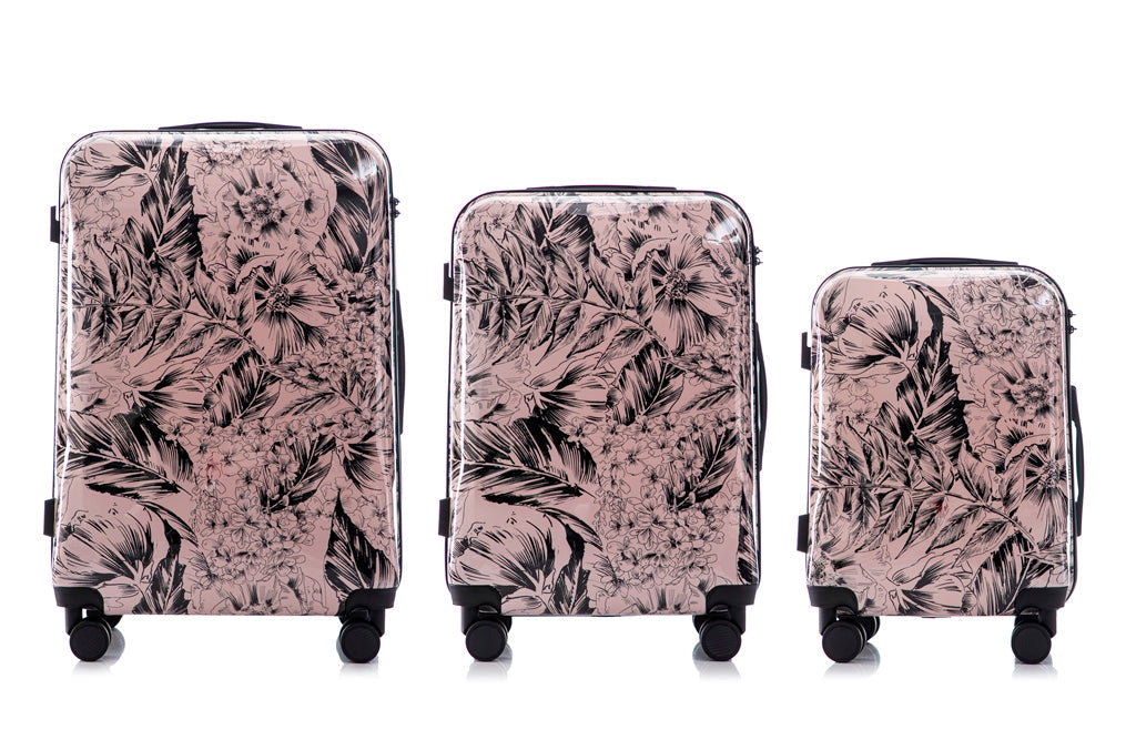 Set of three floral-patterned suitcases on a white background
