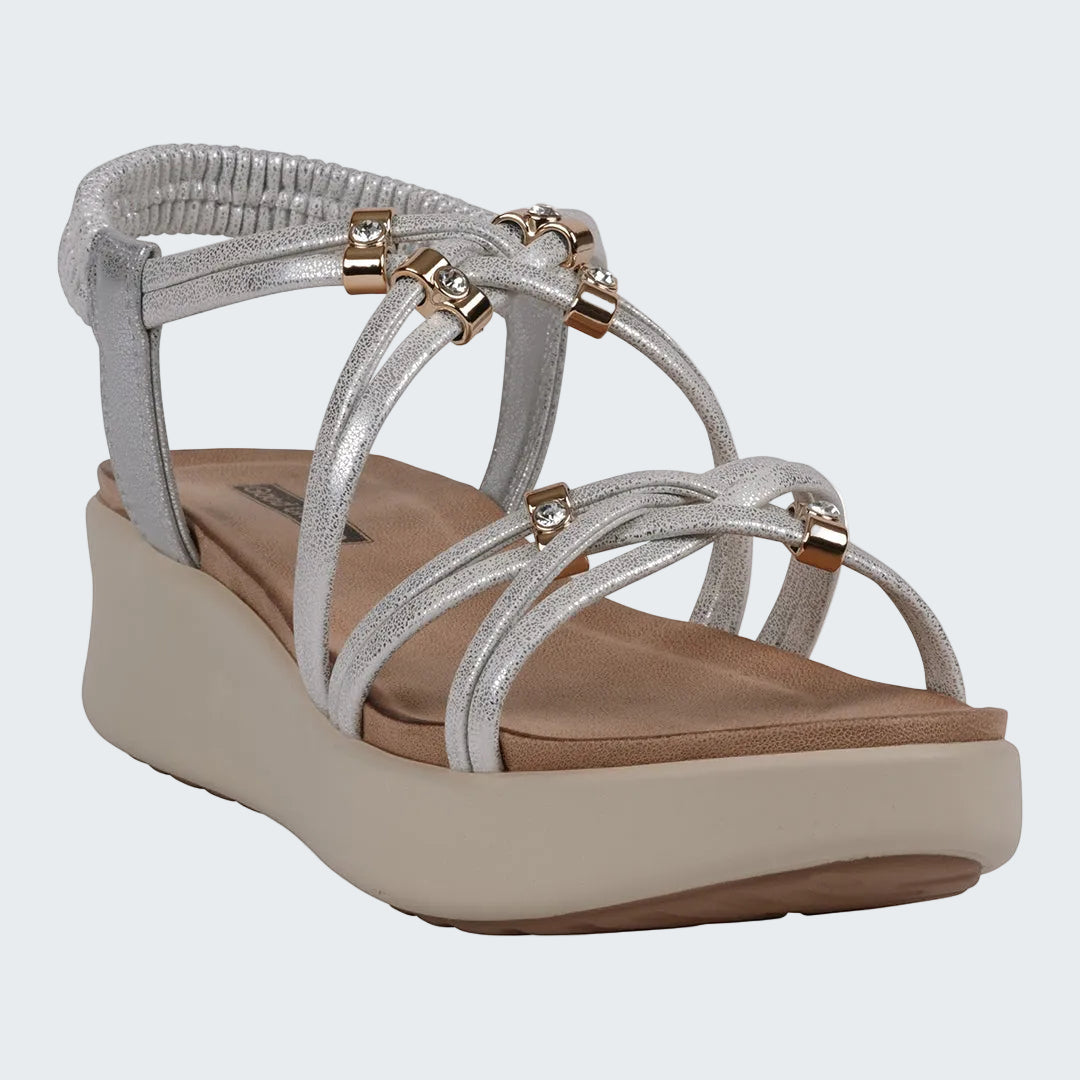 Silver strappy sandal with a beige platform sole on a white background