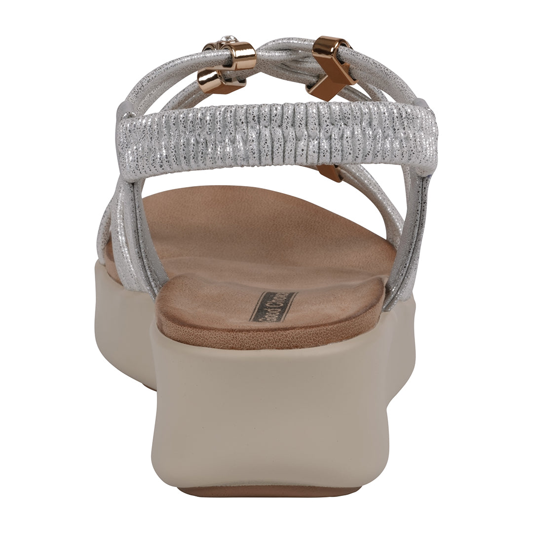 Silver sandal with a brown sole on a white background