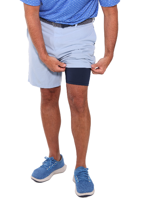 Person wearing light blue shorts and a blue shirt on a white background