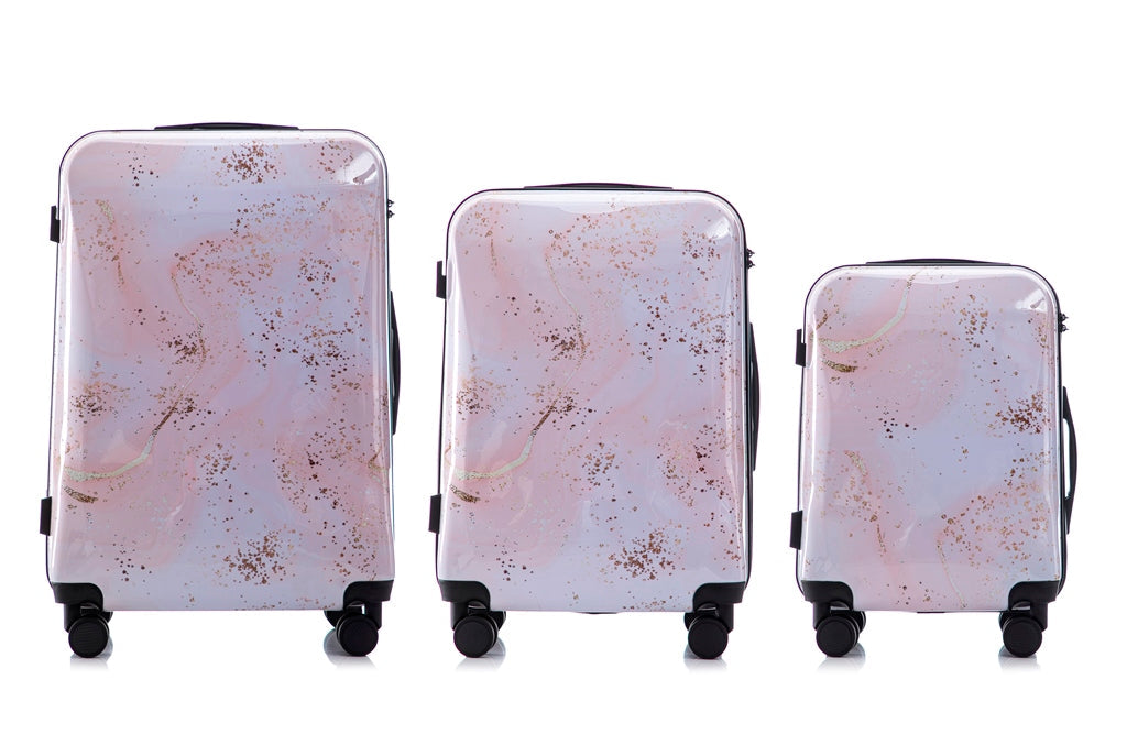 Set of three suitcases with a marble pattern on a white background