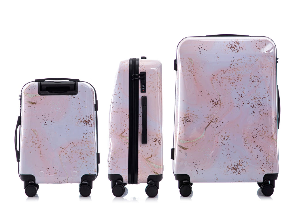 Set of three marble-patterned suitcases on a white background